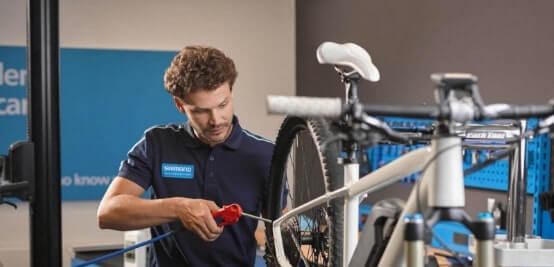 Shimano Service Center employee repairing a bike